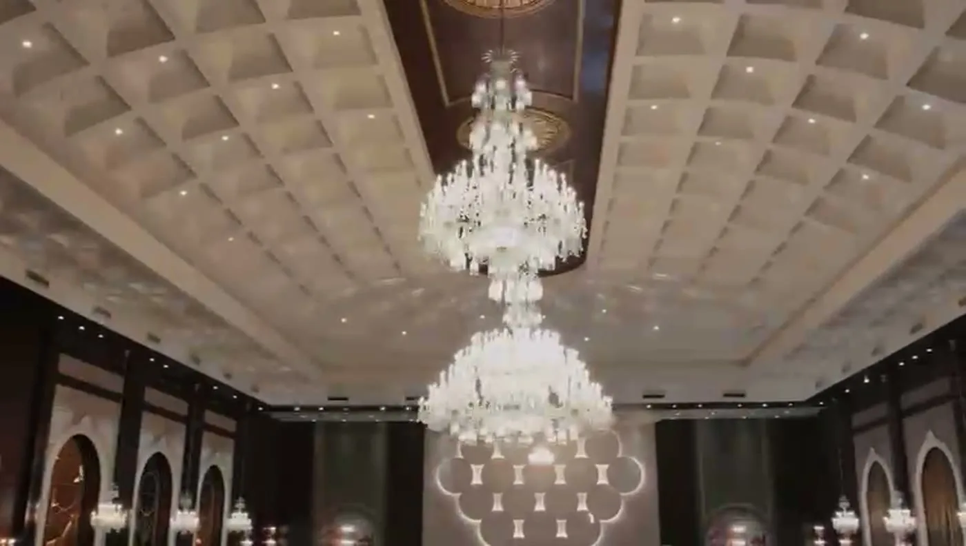 Crystal chandeliers beneath the ornate hall ceiling