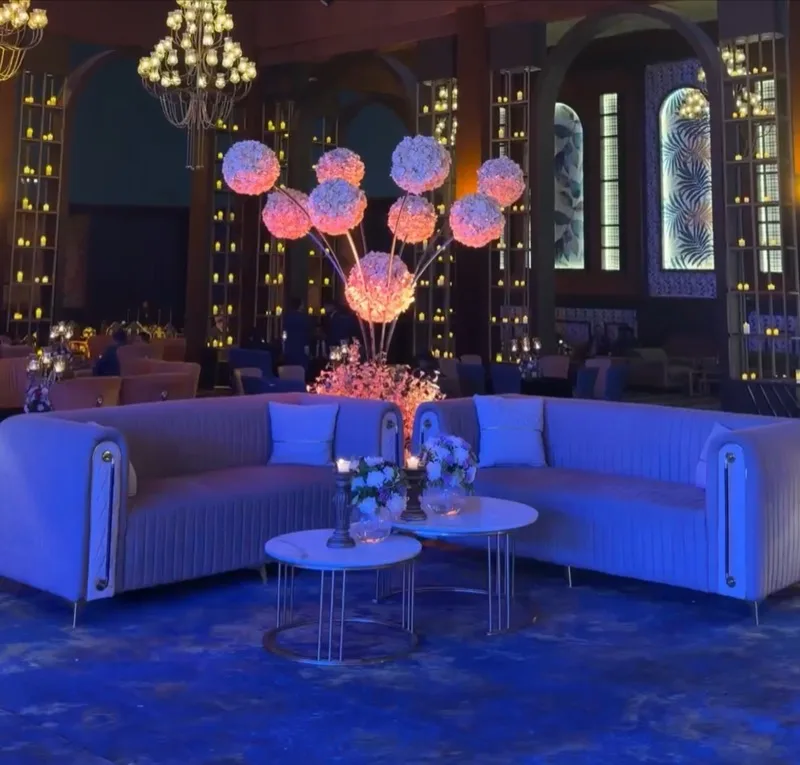 Floral centrepieces and blue-lit lounge seating at Riviera